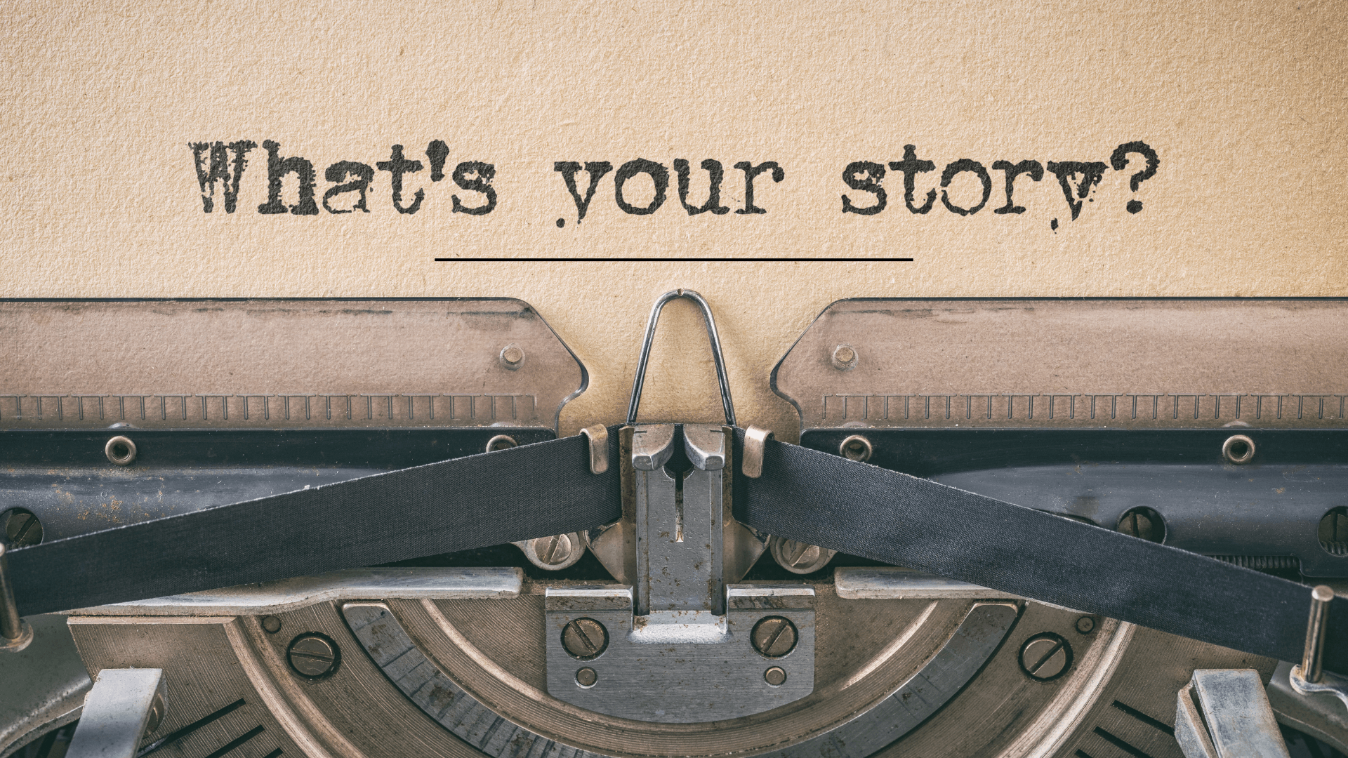 a typewriter with "what's your story" on a piece of paper